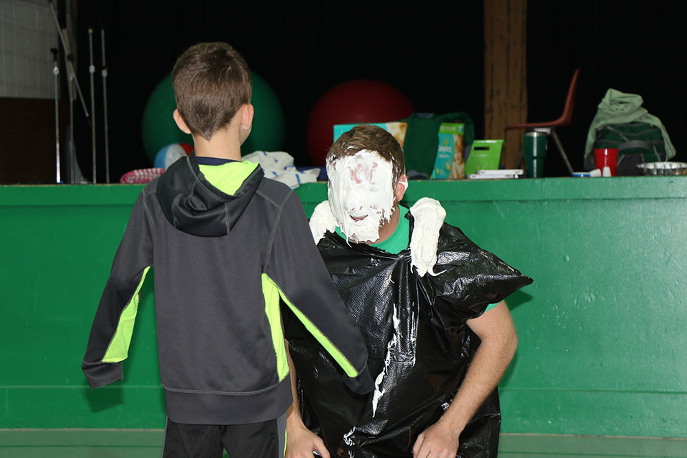 Second grader Lane Roth pies physical education teacher Kellen Basler in the face.