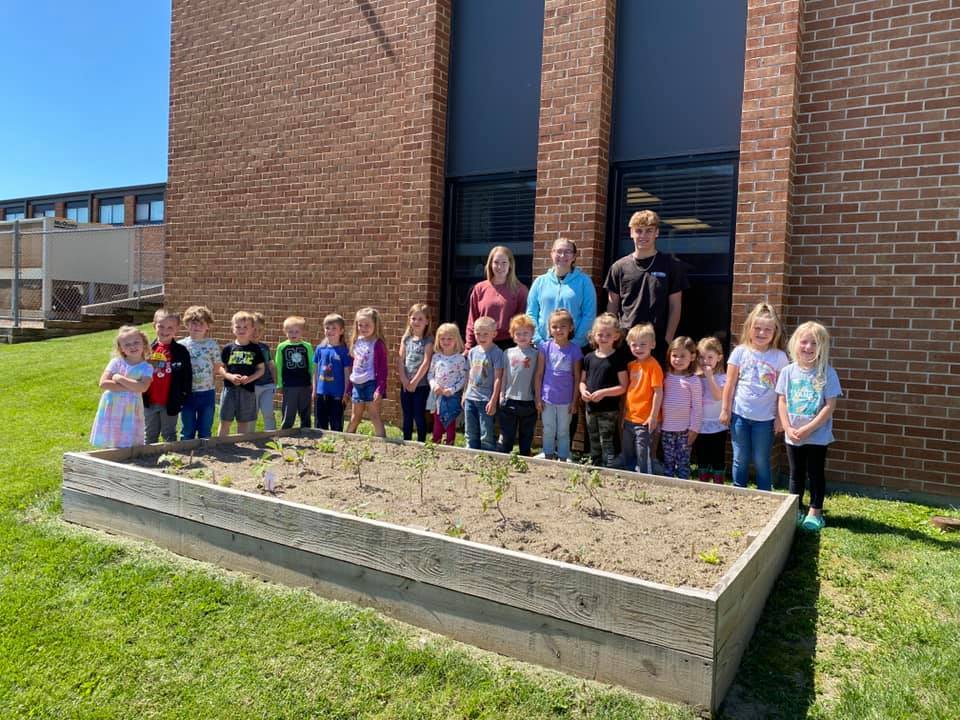FFA Students Guide Preschool Students in Planting a Garden 
