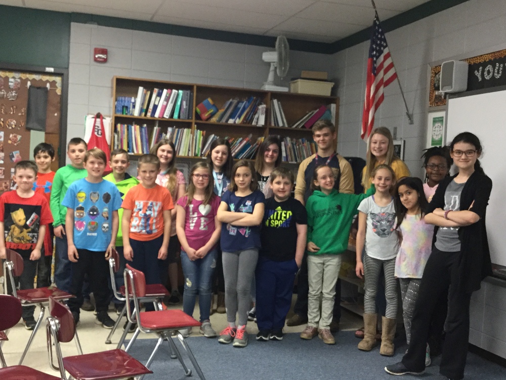 The students pose for a group photo.