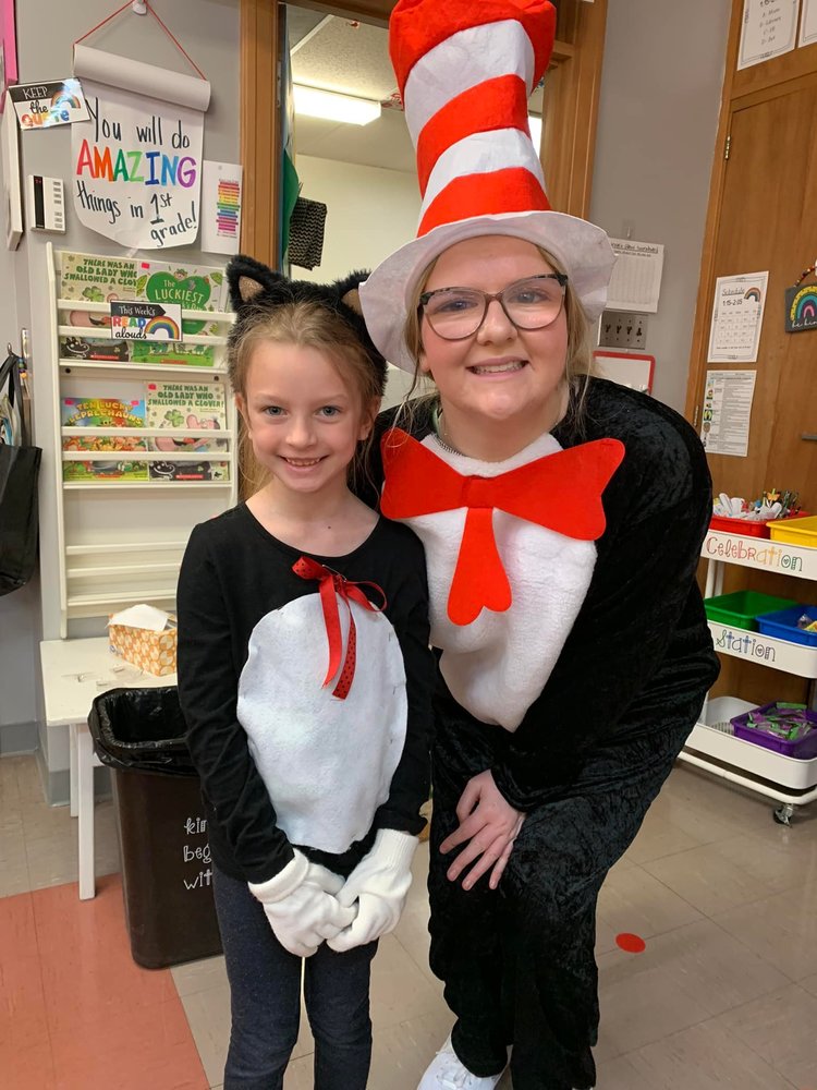 An elementary student and a high school student both dress up as the cat in the hat.